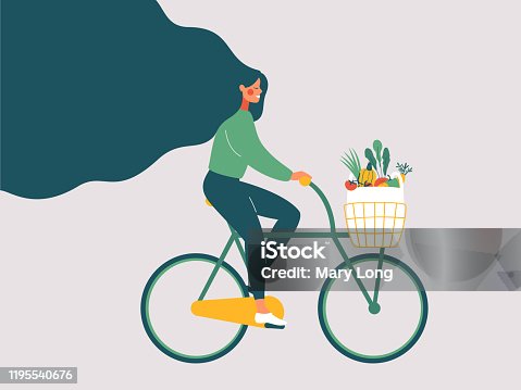 istock Young smiling girl with long hair riding bicycle with fresh vegetables in front basket. 1195540676