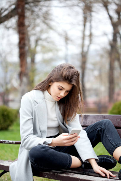 istock beautiful woman with smart phone 1195540835