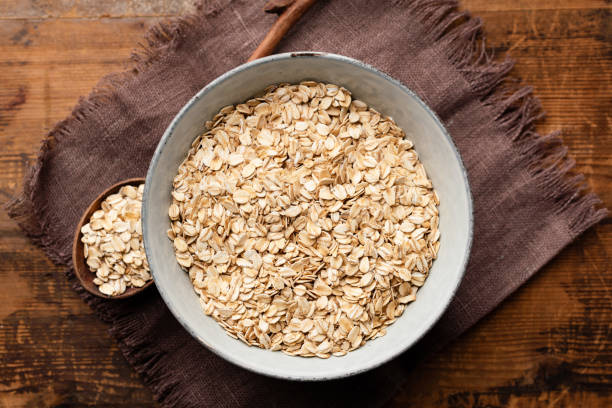 istock Oats, rolled oat flakes or oatmeal in bowl 1195541188