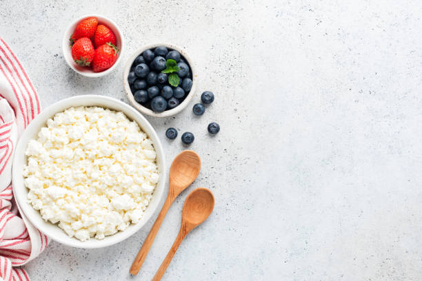 Curd cheese or cottage cheese or tvorog in bowl Curd cheese or cottage cheese or tvorog in bowl served with fresh summer berries. Copy space for text, top view. Healthy food, homemade cheese cottage cheese photos stock pictures, royalty-free photos & images