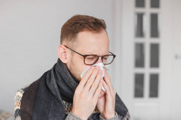 istock Young caucasian man catched a cold, blowing his nose. 1195541928