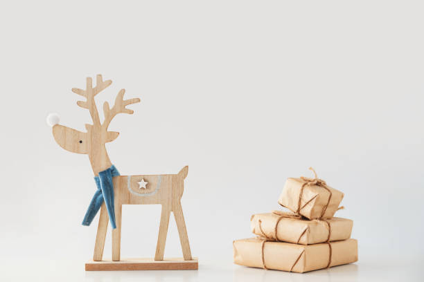 istock Toy deer carries a stack of gift boxes. Christmas and New Year concept 1195542533