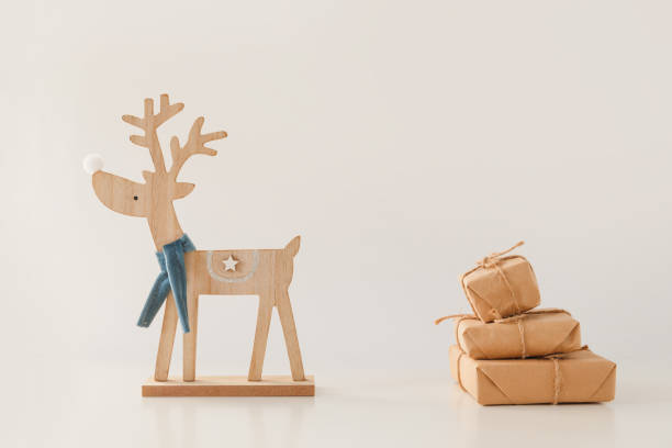 istock Toy deer carries a stack of gift boxes. Christmas and New Year concept 1195542535