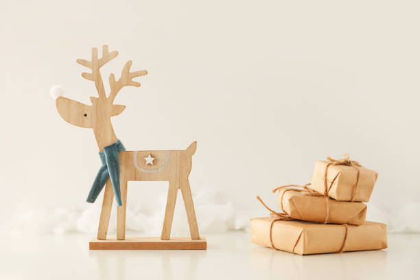 istock Toy deer carries a stack of gift boxes. Christmas and New Year concept 1195542536