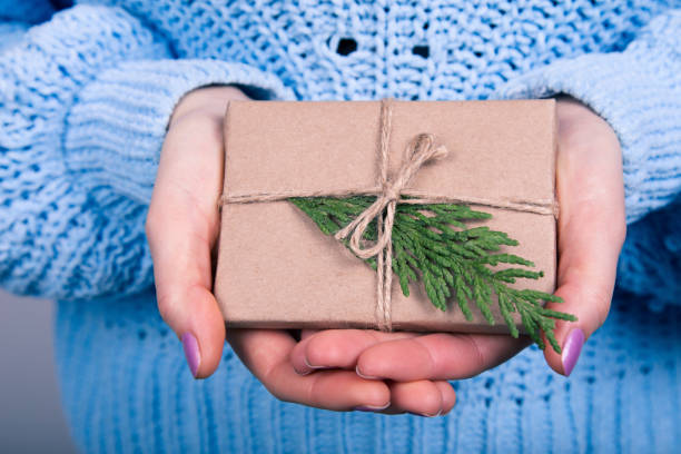 istock Female Holding Rustic Decorated Christmas Gift 1195542795