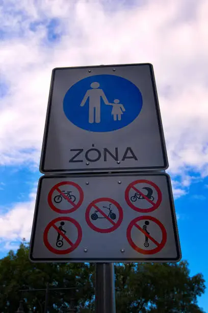 Pedestrian zone sign. Table with sign prohibiting riding scooters, bicycles, carts, monowheels and segway. Budapest, Hungary.
