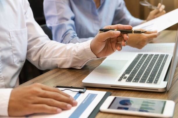 istock Business team brainstorming and discussing with financial data and report graph. Teamwork meeting working concept. 1195544219
