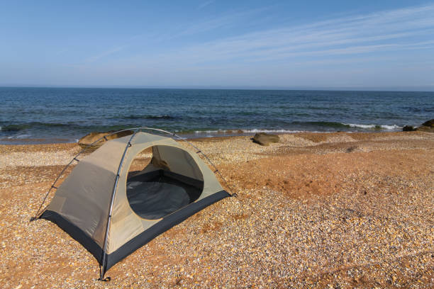istock white touristic tent on a sea coast 1195544488