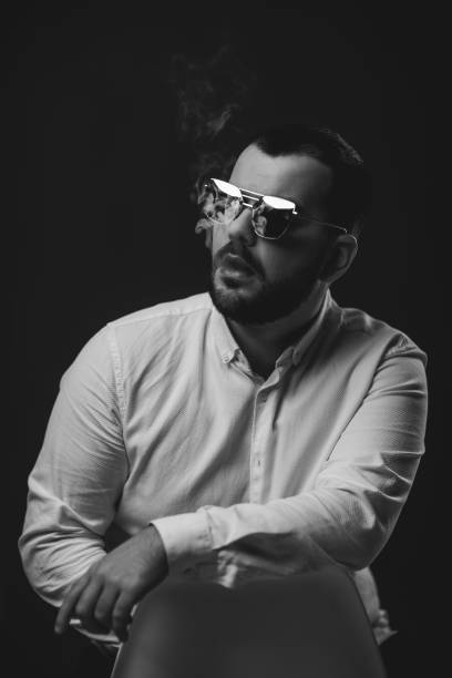 istock man in sunglasses and white shirt smoking 1195545353