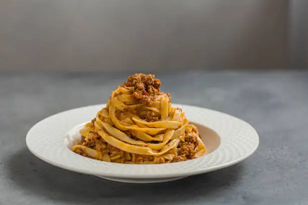 Tagliatelle al ragù alla Bolognese - long, flat egg pasta with a meat sauce or Bolognese sauce.