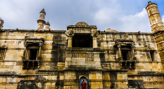 Man at Heritage Jami Masjid also known as Jama mosque in Champaner, Gujarat state, western India, is part of the Champaner-Pavagadh Archaeological Park. Jami Mosque is UNESCO World Heritage Site.