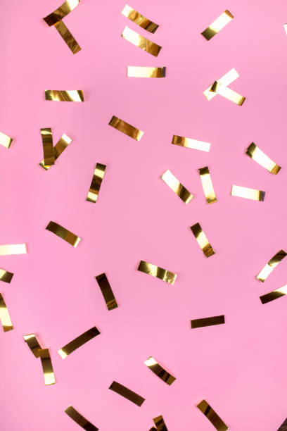 istock Gold confetti on pink background. 1195548880