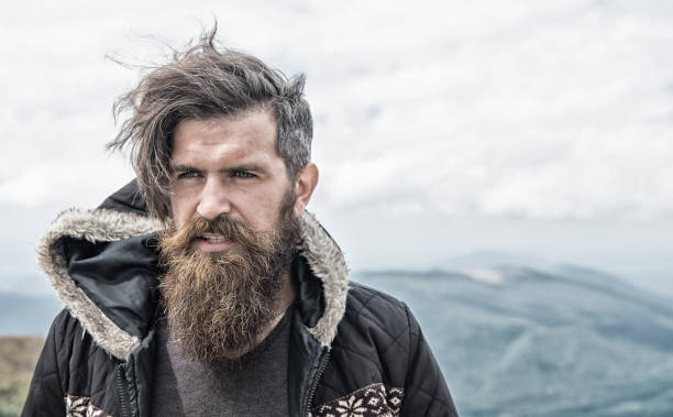 istock bearded handsome serious man on mountain top 1195549988