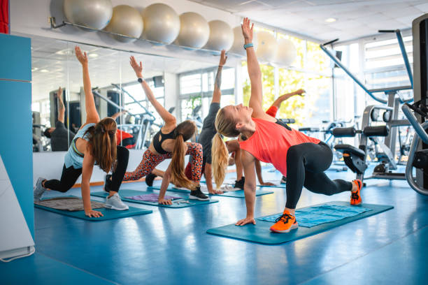 istock Fitness Group Stretching with Instructor at Gym 1195550000