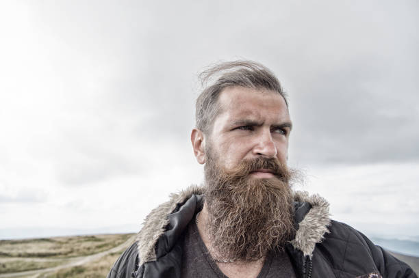istock bearded handsome serious man on mountain top 1195550694