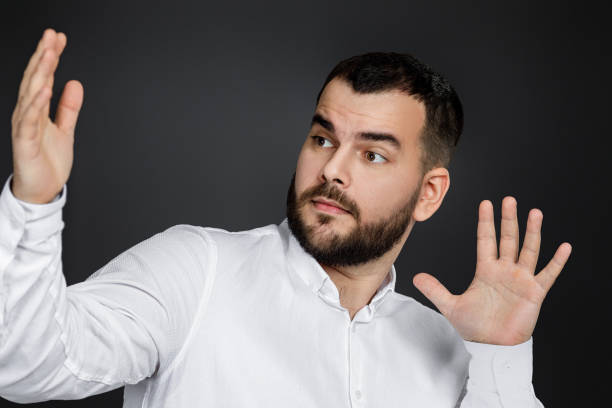 istock handsome bearded man showing the size 1195550862