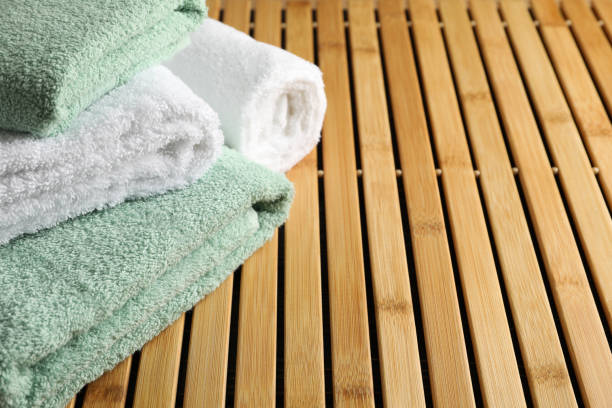 istock Folded towels on bamboo background, close up and copy space 1195550991