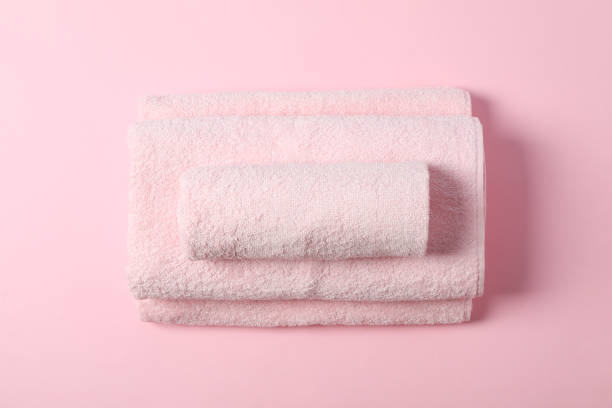 istock Composition with folded towels on pink background, top view 1195551530