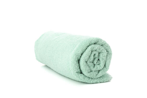 istock Rolled green towel isolated on white background, close up 1195551568
