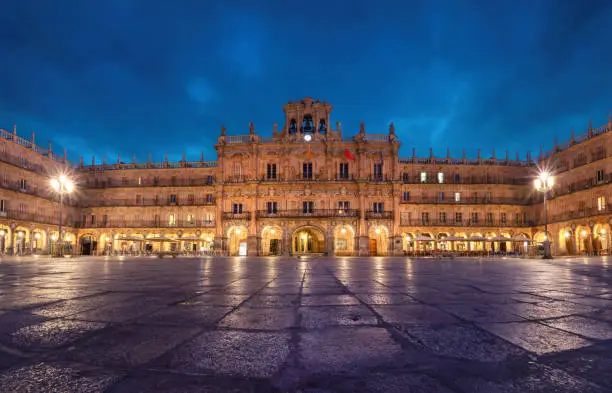 Salamanca, Spain. View of Plaza Mayor at dusk - 18th-century Spanish baroque public square bordered by shops, restaurants and Town Hall.