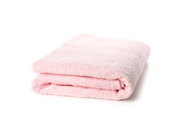 istock Folded pink towel isolated on white background, close up 1195552332