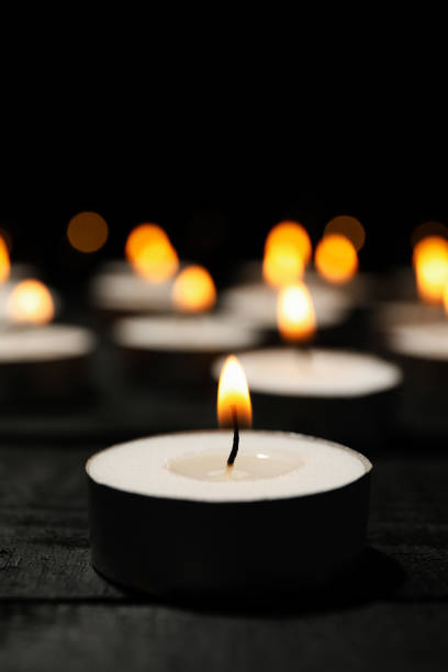 istock Group of burning candles on black background, close up 1195553600