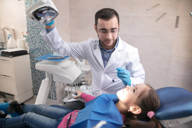 istock Young caucasian girl visiting dentist's office 1195553684