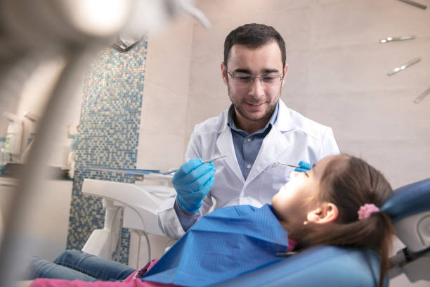 istock Young caucasian girl visiting dentist's office 1195553685