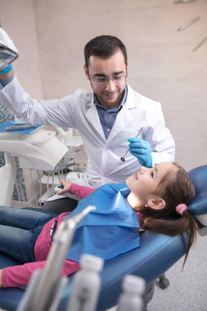 istock Young caucasian girl visiting dentist's office 1195553693