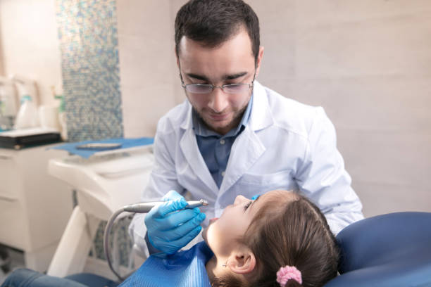 istock Young caucasian girl visiting dentist's office 1195553719
