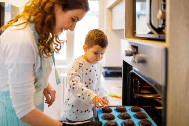 istock Boy grabing hot muffins 1195554420