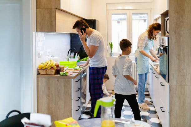 istock Family of four in kitchen 1195554526