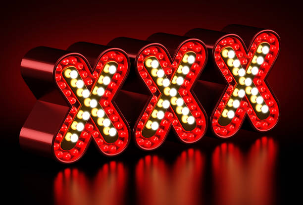 istock Illuminated XXX letters standing on black surface 1195554779