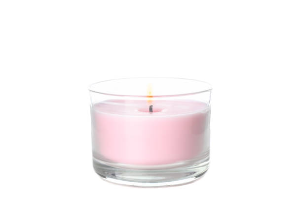 istock Pink burning candle in glass jar isolated on white background 1195554816