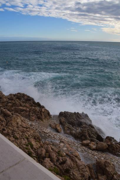 istock Sea waves splashing on rocky coast 1195554885