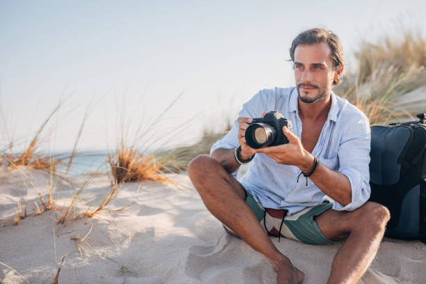 Midsection Of Man Holding Camera