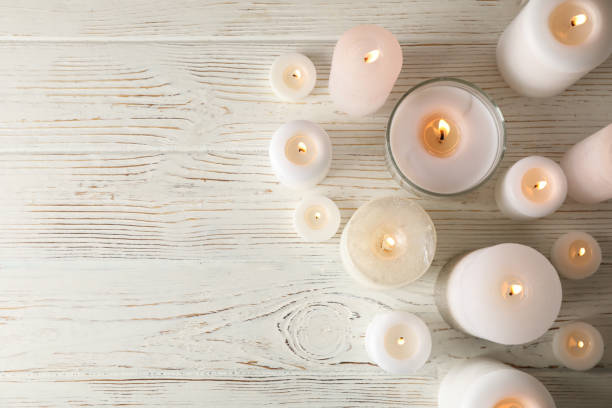 istock Different burning candles on wooden background, top view 1195555681