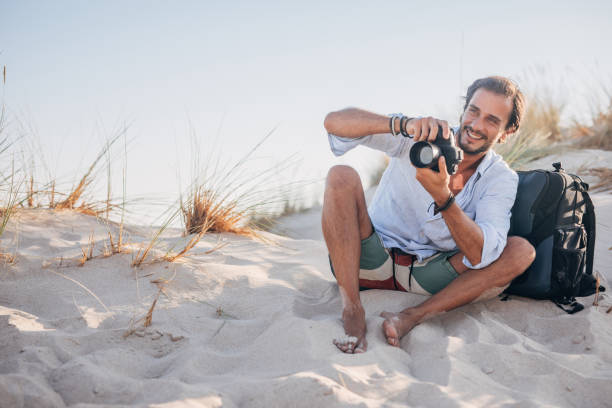 Director of photography adjusting some camera settings., Sardinia, Italy.