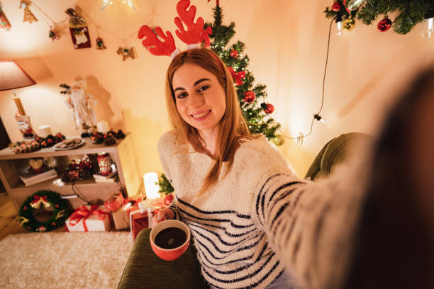 istock Woman making selfie with Christmas tree 1195555875