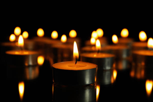 istock Group of burning candles on black background, close up 1195555944