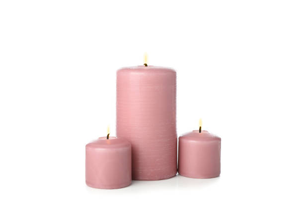 istock Pink burning candles isolated on white background 1195556089