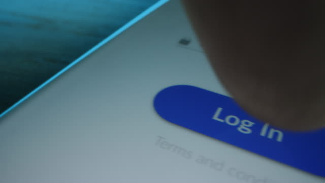 Close-up Macro Shot: Smartphone with App Showing Authorization Screen asking to Enter Username and Password, Finger Clicks Log In Button. Touch Screen Phone Device with Mock-up Sign in Access Window
