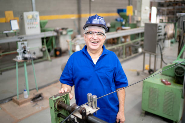 istock Portrait of a happy engineer using protective workwear while working in a factory 1195558538