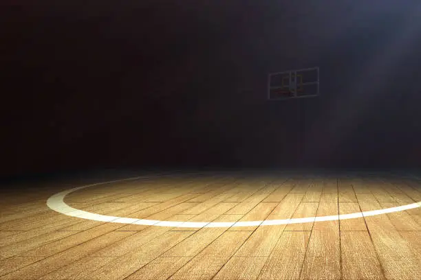 Photo of Basketball court with wooden floor and a basketball hoop