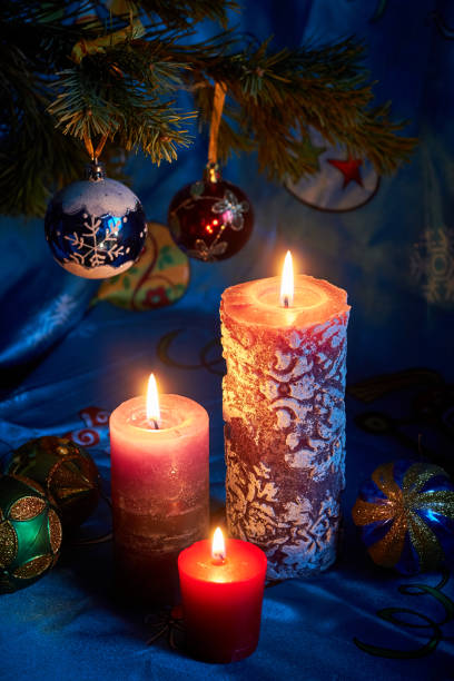 istock Christmas candles on blue background 1195560215