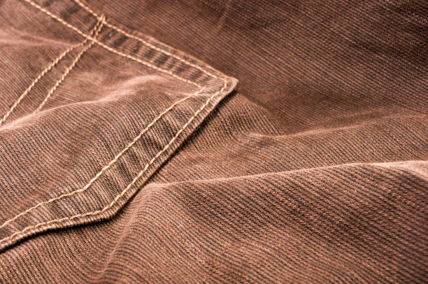 istock clothing items stonewashed cotton fabric texture with seams, clasps, buttons and rivets, macro 1195560607