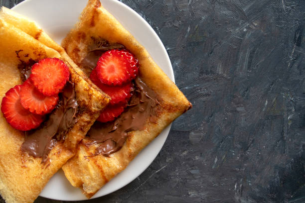 istock Fresh pancakes with chocolate paste and strawberry on gray background with copy space. 1195561499