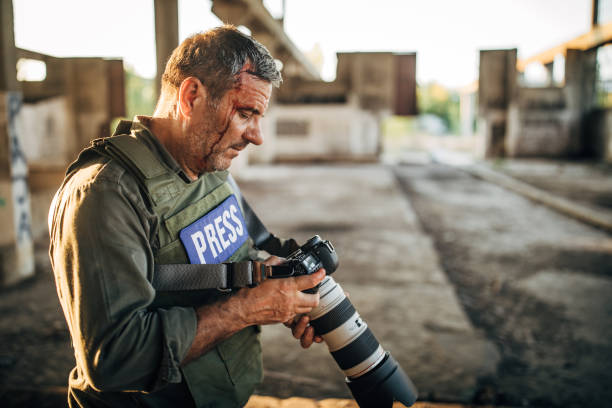 istock Mature man war photographer in abandoned building 1195563010