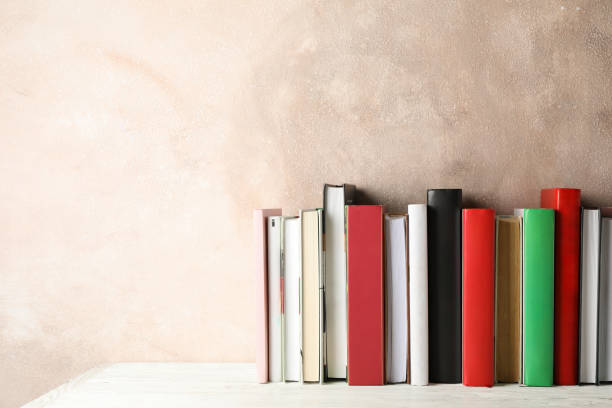 istock Books against brown background, space for text 1195563094