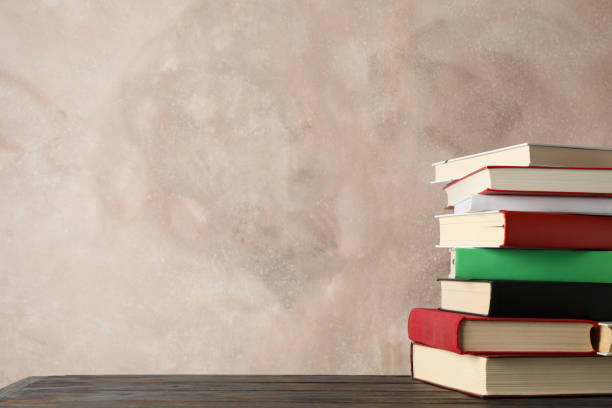 istock Stack of books against brown background, space for text 1195563864